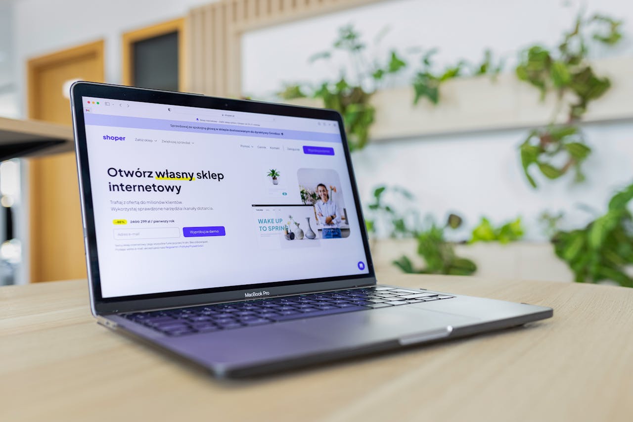 services-02 Close-up of a laptop with an open e-commerce website, surrounded by modern office decor.